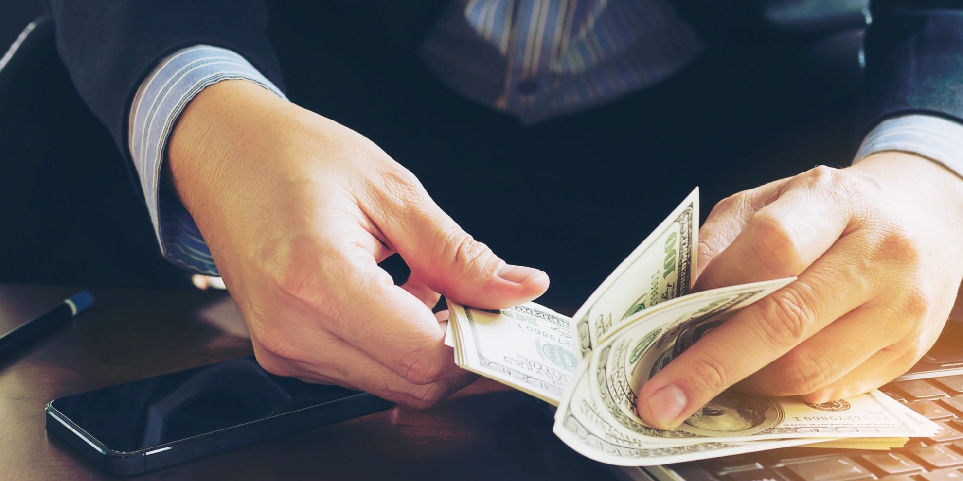 Business man counting dollar banknote – online business concept 5 tips to protect your business from internal theft