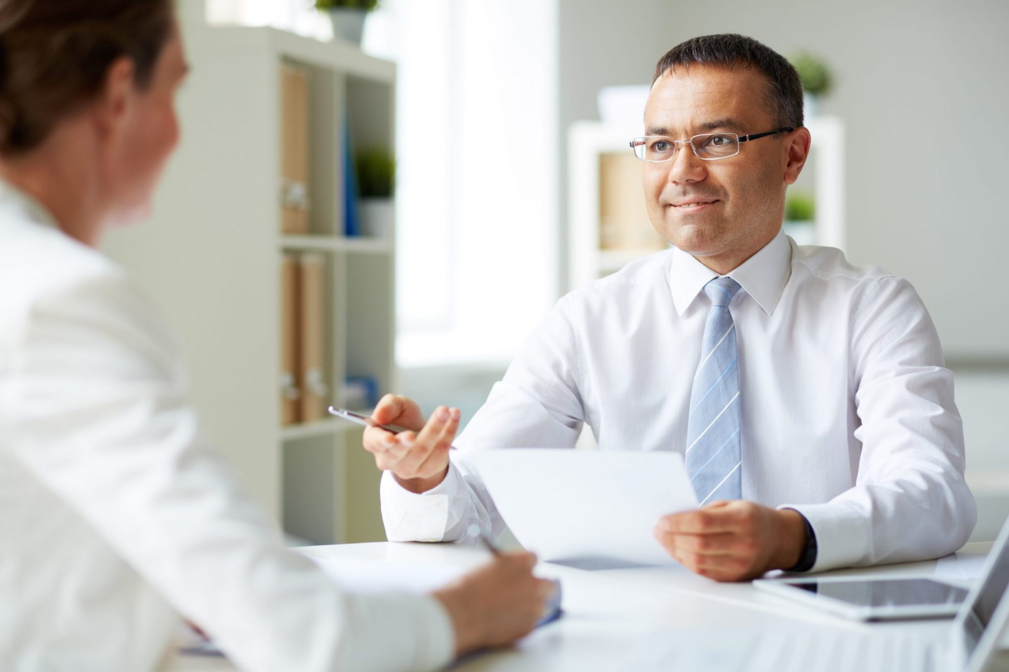 Photo of executive making an interview illustrates blog: Why Are Background Checks Important?