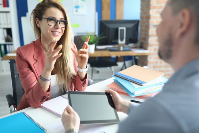 Image of smiling confident woman illustrates blog: "Employee Retention: Here’s How Background Screening Can Help"