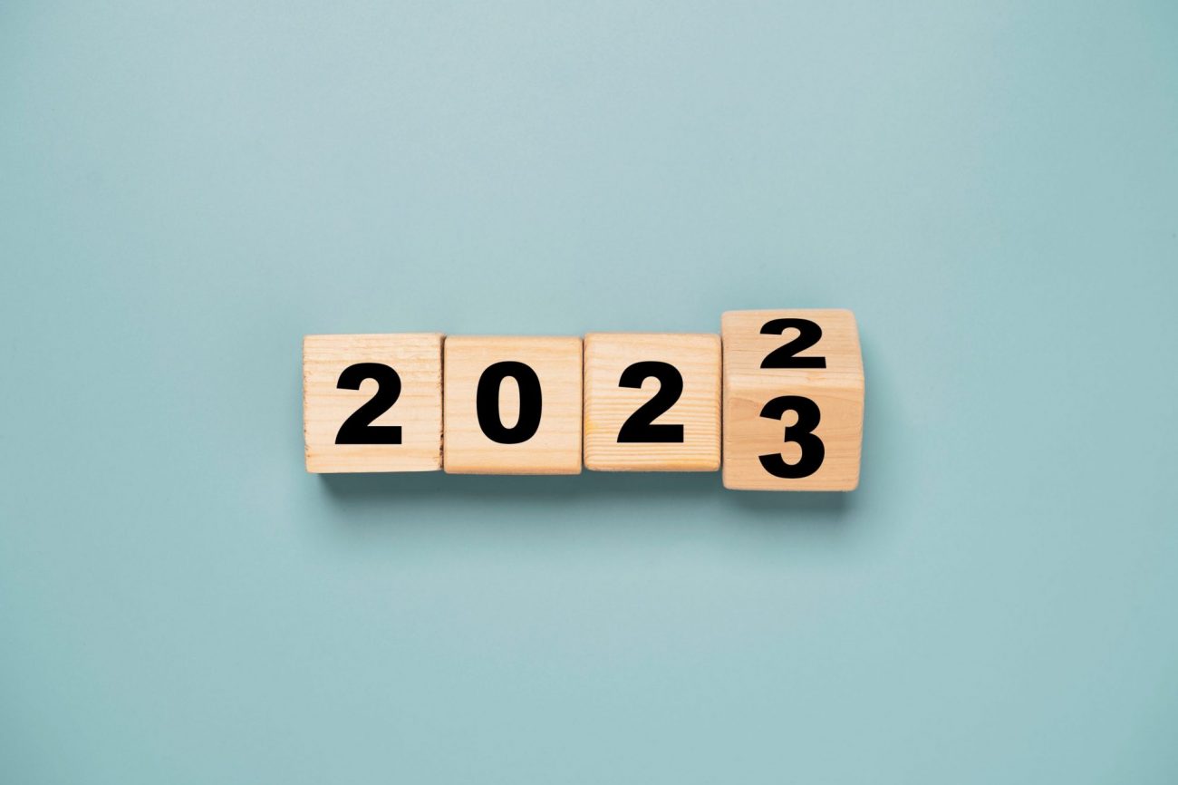 Wooden cubes that show the date changing from 2022 to 2023 illustrates blog: "4 Workplace Trends To Watch in 2023"