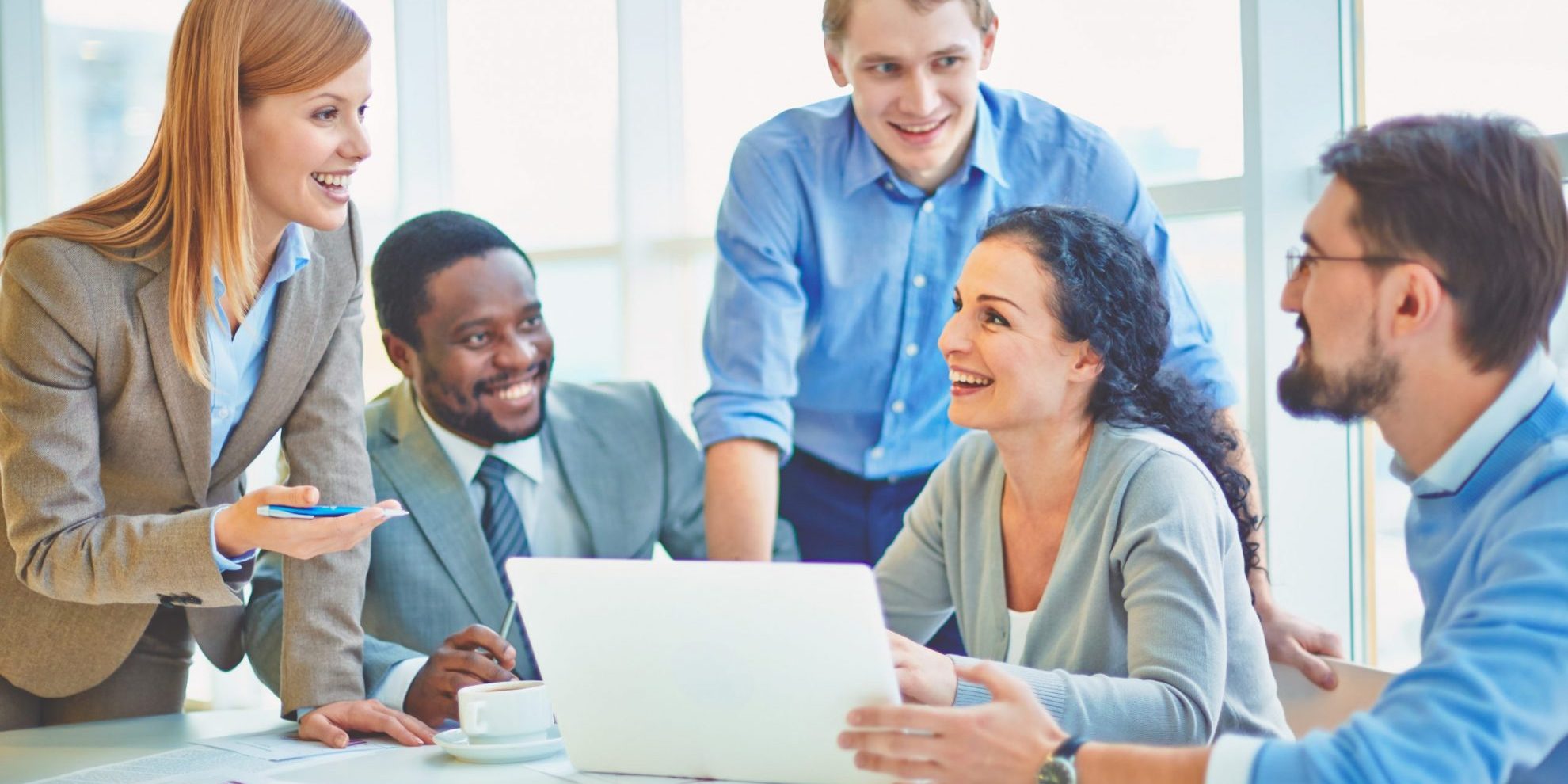 Photo of employees in conversation illustrates blog: "Types of Incentive Programs: What You Need To Know"