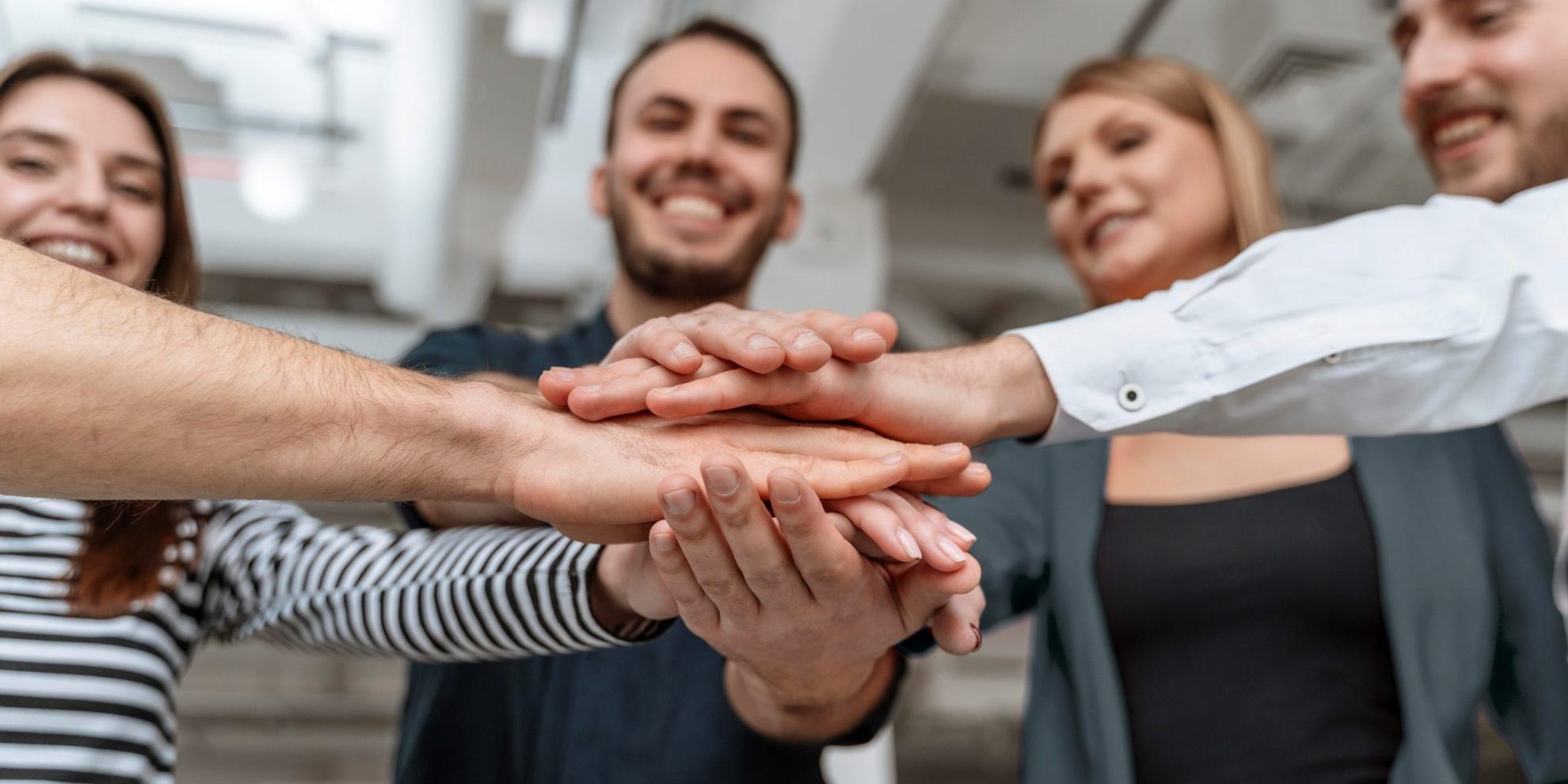 InternalHiring Group of people joining hands illustrates blog "5 Tips to Get Internal Hiring Right"