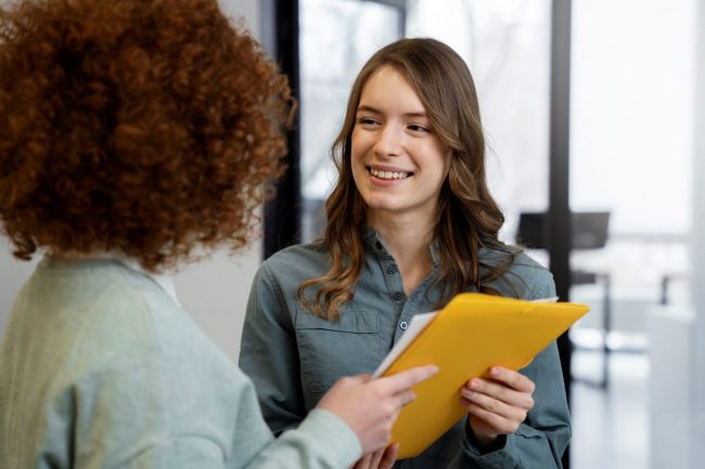 recruitment-tips-FP Women holding folder illustrates blog "5 Recruitment Tips for Hiring Managers"
