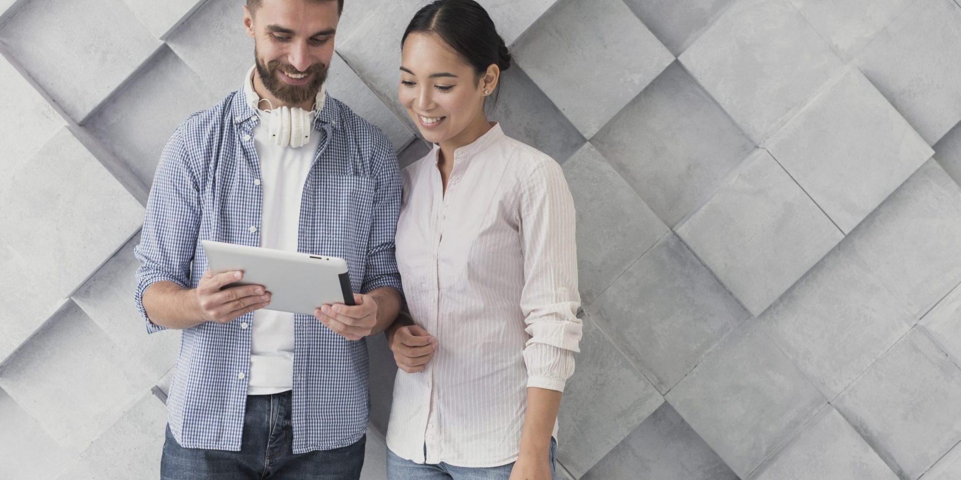 man-woman-casual-fp Man and woman looking at tablet illustrate blog "How to Evaluate a Candidate's Soft Skills"
