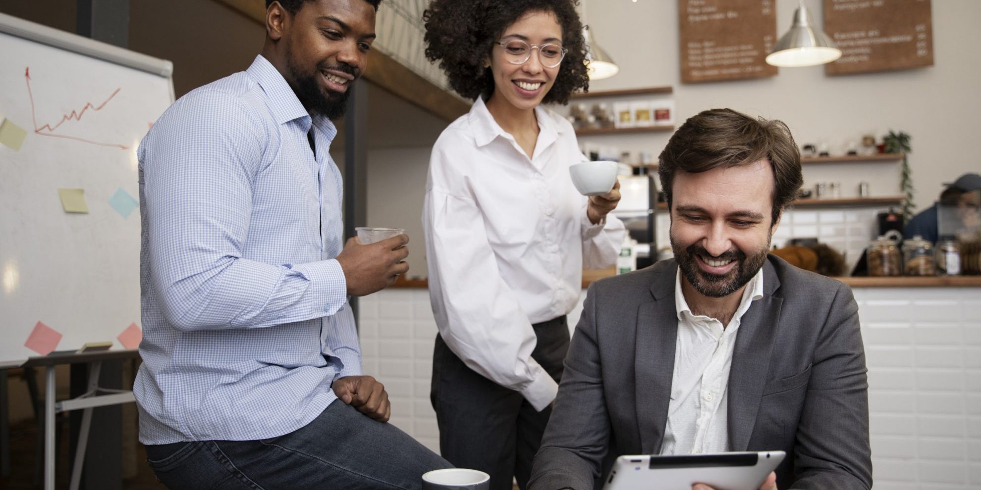 workplace-DEI-fp Group of three people looking at tablet illustrates blog "What Is DEI in the Workplace?"
