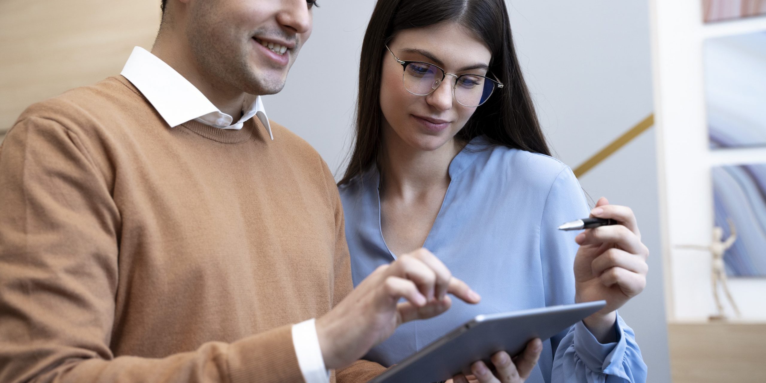 Man and woman looking at tablet in office
