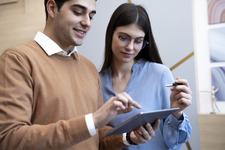 Man and woman looking at tablet in office