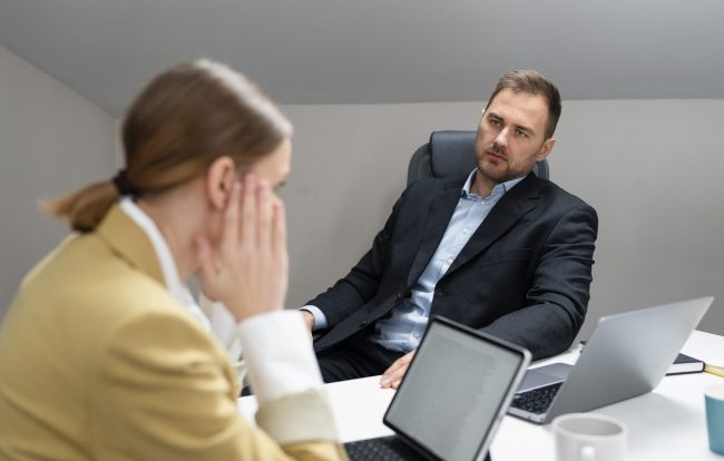 candidate-interview-fp Man and woman in office during job interview.