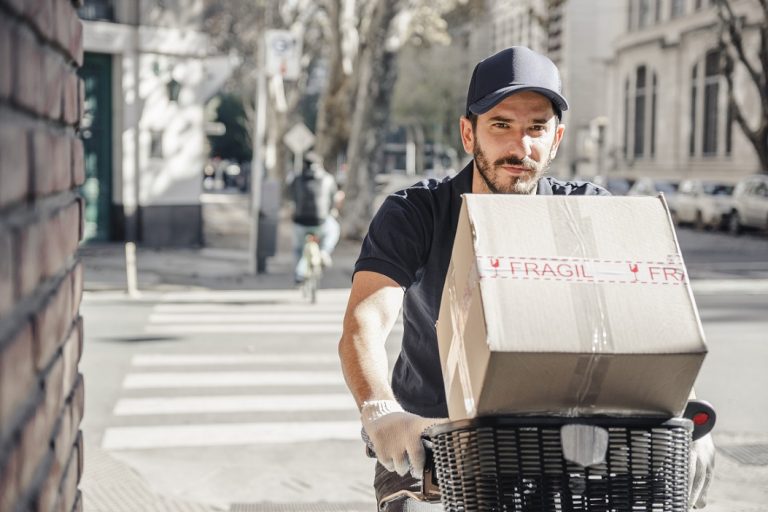 Man riding bicycle illustrates blog "The Gig Economy and Background Screening"