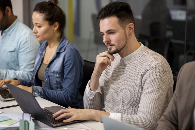Man looking at computer illustrates blog "Understanding Different Types of Background Checks and Their Applications"