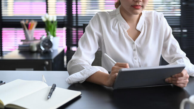 HR manager reviewing background check compliance documents on laptop