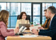 HR team discussing employee re-screening policy and role changes
