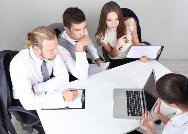 HR team preparing for a background screening audit with a compliance checklist