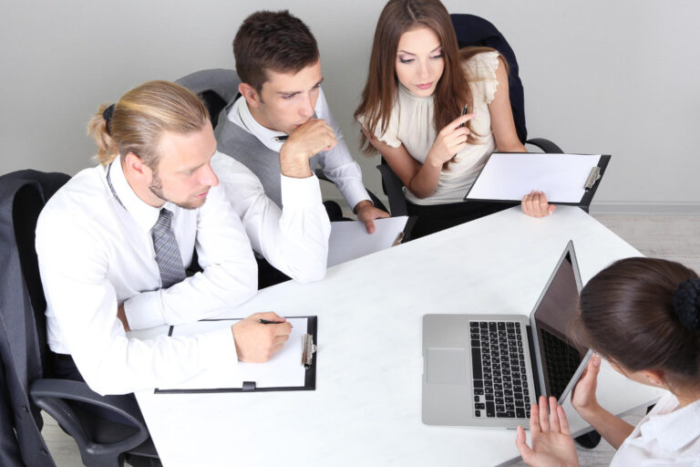HR team preparing for a background screening audit with a compliance checklist